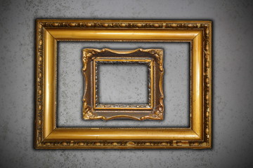 two ancient empty frames on grungy wall