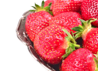 strawberries in metal bowl isolated on white background