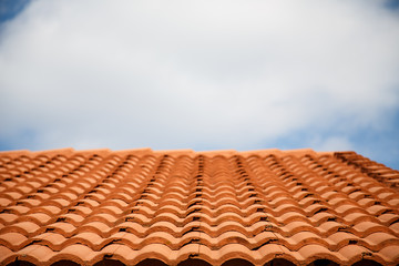 Roof of Red Clay Tiles Under Cloudy Skies