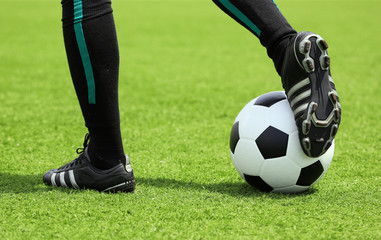 soccer ball with foot of player touching it