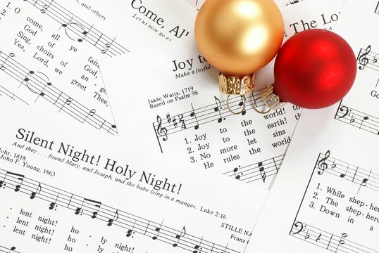 Music notes with Christmas carol and Christmas ornaments