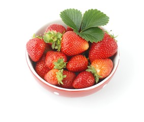 Red bowl with strawberies on white background