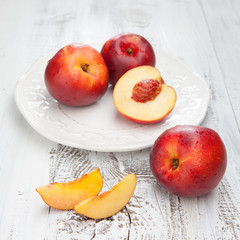 Naklejka na ściany i meble Fresh and tasty peaches on a table