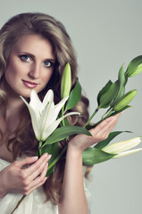 Beautiful young woman with white lily