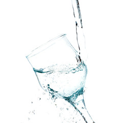 Fototapeta na wymiar Water splashing in a glass