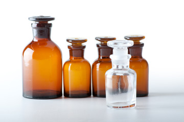 Small chemical glass bottles on white background