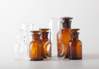 Small chemical glass bottles on white background