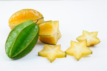 Carambola fruit with slices isolated on white background