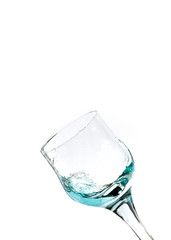 Splash of blue water into the glass