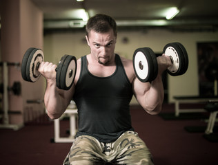 Bodybuilder is doing heavy weight biceps excercise