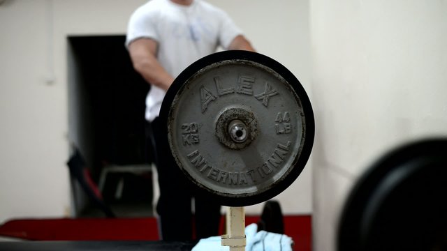 bodybuilder putting weights