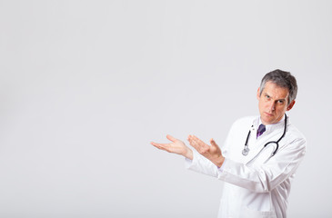 Doctor listening to empty copy space with stethoscope