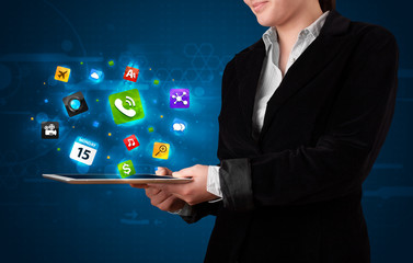 Lady holding a tablet with modern colorful apps and icons