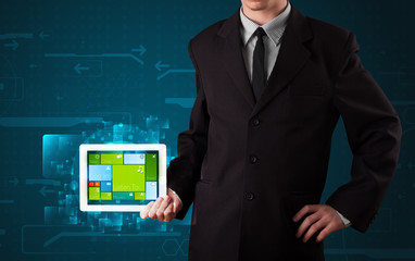Businessman holding a tablet with modern software operational sy