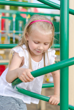 Little girl playing on the playground