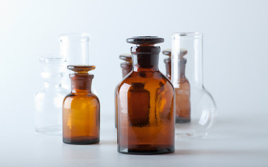Small chemical glass bottles on white background