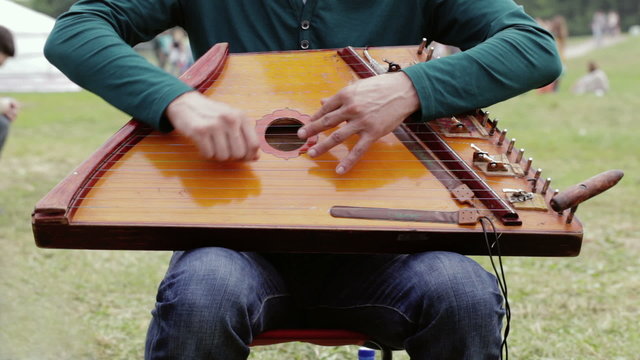 Folk musician playing gusli
