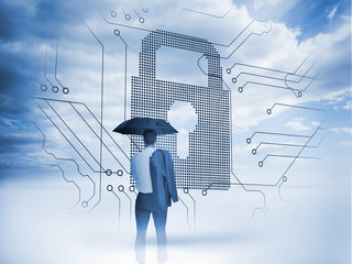 Businessman under an umbrella looking at a big padlock