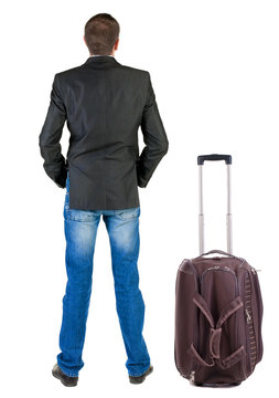 Back view of traveling busness man with  suitcase