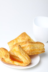 Breakfast with coffee and croissants on white background