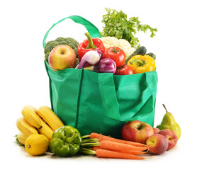 Green shopping bag with grocery products on white background