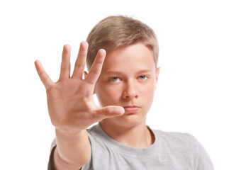 Teenage boy making stop gesture