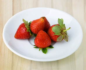 Strawberries on a white dish