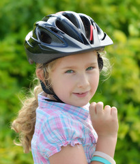 Young girl in a bicycle helmet.