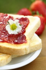 Close-up of toast with strawberry jam on plate..