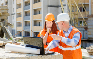 builders at work with a laptop