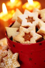 Christmas cookies in red tin and candles