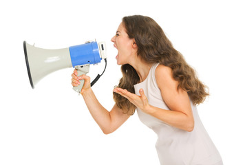 Fototapeta premium Angry young woman shouting through megaphone