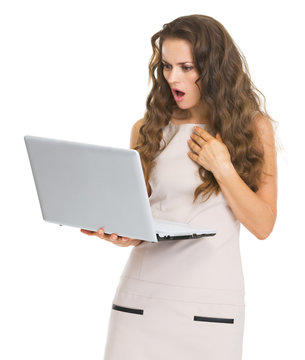 Surprised young woman with laptop