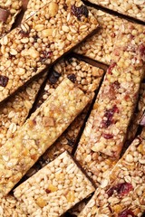 Top view of various cereal bars with dry fruits and nuts.