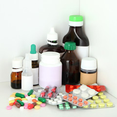 Medical bottles and pills on shelf