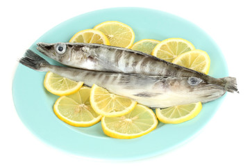 Fresh fish with lemon on plate isolated on white