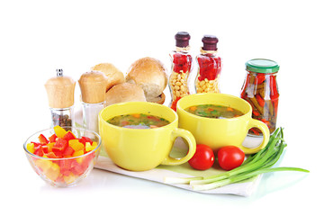 Fragrant soup in cups isolated on white