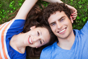 Young couple lying on grass