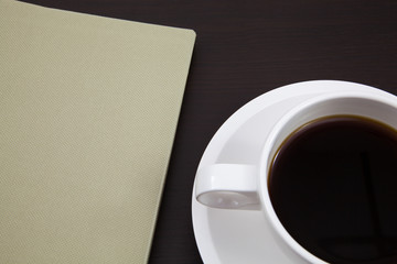 Obraz na płótnie Canvas Cup of coffee and book