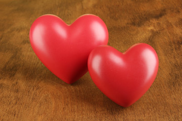 Fototapeta premium Two red heart shapes on rustic wooden background love and romance concept valentine's day celebration relationship and affection