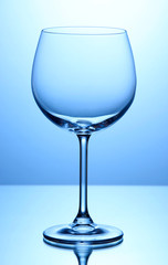Empty wine glasses arranged on blue background