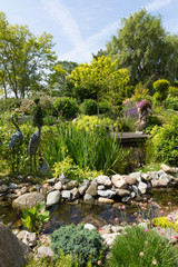 Beautiful garden with pond and several ornaments