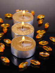 Golden candles isolated on black
