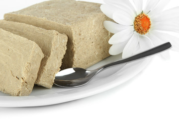 Tasty halva on plate isolated on white