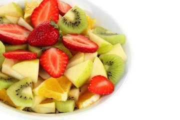 Useful fruit salad of fresh fruits and berries in bowl isolated