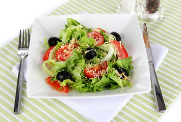 Light salad on plate on napkin