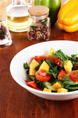 Light salad in plate on wooden table