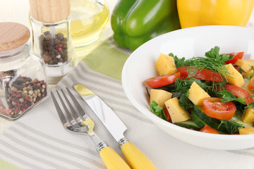 Light salad in plate on wooden table