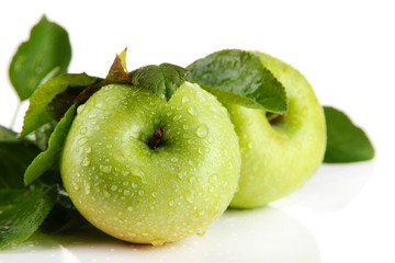 Juicy green apples with leaves, isolated on white