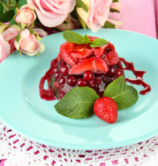Tasty jelly dessert with fresh berries, on pink roses